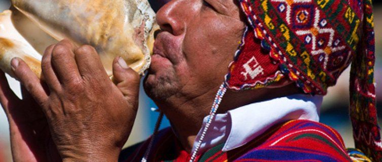 A man blows a shell at Peru's Qoyllur Rit’I
