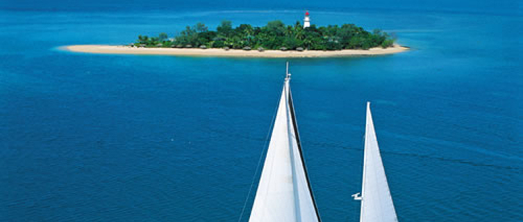 A yacht floats past the pristine and pintsized Low Isles