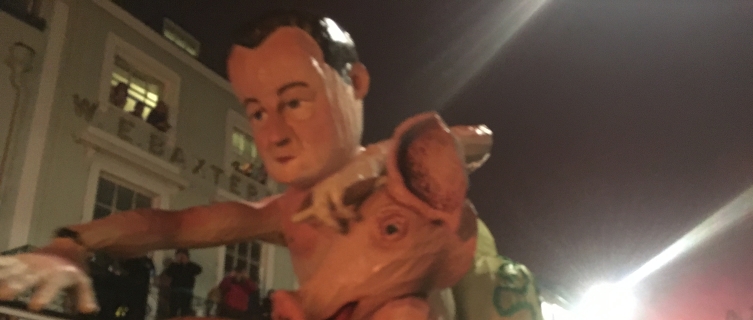 An effigy of David Cameron makes its way through the crowd